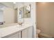 Bathroom featuring a toilet, large mirror, white cabinets, and a sink with a silver faucet at 1038 Silver Creek Ave, Las Vegas, NV 89183