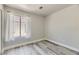 Cozy bedroom with natural light from the window with white curtains and laminate floors at 1038 Silver Creek Ave, Las Vegas, NV 89183