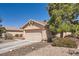 Well-maintained single-story home with desert landscaping, arched entryway, and a two-car garage at 1038 Silver Creek Ave, Las Vegas, NV 89183