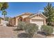 Well-maintained single-story home with desert landscaping, arched entryway, and a two-car garage at 1038 Silver Creek Ave, Las Vegas, NV 89183