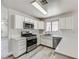 This bright kitchen features white cabinets, stainless steel appliances, and solid surface countertops at 1038 Silver Creek Ave, Las Vegas, NV 89183