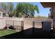 Partially fenced backyard with artificial grass and gravel at 1081 Elation Ln # 2, Henderson, NV 89002