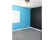 Bedroom with contrasting blue and black walls, carpet and a window for natural light at 1081 Elation Ln # 2, Henderson, NV 89002