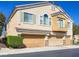 Charming townhome featuring a three-car garage, a quaint balcony, and a well-maintained front yard at 1081 Elation Ln # 2, Henderson, NV 89002
