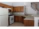 Traditional kitchen with honey-toned cabinets, white appliances, and neutral countertops at 1081 Elation Ln # 2, Henderson, NV 89002
