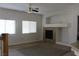 Bright living room featuring a ceiling fan, a fireplace, and large windows at 1081 Elation Ln # 2, Henderson, NV 89002