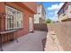 Rear patio area featuring mature landscaping and views of the neighborhood at 10918 Avenzano St, Las Vegas, NV 89141
