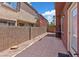 Fenced backyard featuring a concrete patio, desert landscaping, and views of neighboring properties at 10918 Avenzano St, Las Vegas, NV 89141