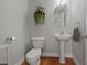 Clean bathroom with toilet, pedestal sink, oval mirror, and tile flooring at 10918 Avenzano St, Las Vegas, NV 89141