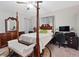 Traditional bedroom features a wooden four poster bed, matching furniture, and a ceiling fan at 10918 Avenzano St, Las Vegas, NV 89141