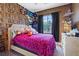 bedroom featuring colorful wallpaper, playful decor, and comfortable carpeting at 10918 Avenzano St, Las Vegas, NV 89141