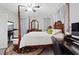Comfortable bedroom features a wooden four poster bed, matching furniture, and a ceiling fan at 10918 Avenzano St, Las Vegas, NV 89141