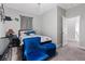 Comfortable bedroom featuring a blue chair and ottoman and an open doorway at 10918 Avenzano St, Las Vegas, NV 89141