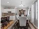Open-concept dining room with a spacious table, elegant china cabinet, and natural light at 10918 Avenzano St, Las Vegas, NV 89141