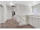 Bright hallway with carpet flooring, leading to bedrooms and featuring built-in storage cabinets at 10918 Avenzano St, Las Vegas, NV 89141