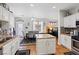 Open kitchen and dining area with granite countertops, stainless appliances, and an island with bar seating at 10918 Avenzano St, Las Vegas, NV 89141