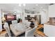 Bright kitchen with white cabinets, stainless appliances, breakfast bar, and dining area, creating an open layout at 10918 Avenzano St, Las Vegas, NV 89141