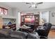 Inviting living room featuring plush seating, a stylish entertainment center, and lots of light at 10918 Avenzano St, Las Vegas, NV 89141