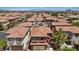 Wide aerial shot of a residential neighborhood featuring homes with tile roofs and landscaping at 10918 Avenzano St, Las Vegas, NV 89141