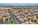 Elevated view of a suburban neighborhood street lined with tile-roofed homes and trees at 10918 Avenzano St, Las Vegas, NV 89141