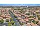Elevated view of a suburban neighborhood street lined with tile-roofed homes and trees at 10918 Avenzano St, Las Vegas, NV 89141