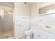 Compact bathroom featuring a tiled wall, glass-enclosed shower, and white fixtures at 1108 Princess Katy Ave, Las Vegas, NV 89119