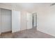 Bedroom features carpeted floors with a closet and view to a bathroom at 1108 Princess Katy Ave, Las Vegas, NV 89119