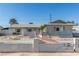 Front exterior of single story home featuring a desert landscape with cinderblock and wrought iron fence in front at 1108 Princess Katy Ave, Las Vegas, NV 89119