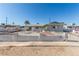 Single story home featuring a desert landscape with cinderblock and wrought iron fence in front at 1108 Princess Katy Ave, Las Vegas, NV 89119