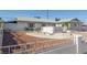 Exterior of single story home with low maintenance desert landscaping and cinderblock and wrought iron fence at 1108 Princess Katy Ave, Las Vegas, NV 89119