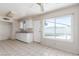 Eat in kitchen with tile flooring, white cabinets and a window at 1108 Princess Katy Ave, Las Vegas, NV 89119