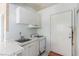 Simple kitchen with a sink, stove, and access to the back door at 1108 Princess Katy Ave, Las Vegas, NV 89119