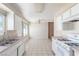 Bright kitchen features white cabinets, tile floors, and ample counter space at 1108 Princess Katy Ave, Las Vegas, NV 89119