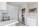 Compact kitchen with essential appliances and a clean white tiled countertop at 1108 Princess Katy Ave, Las Vegas, NV 89119