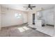 A combined living room and kitchen with white tiling and access to the front door at 1108 Princess Katy Ave, Las Vegas, NV 89119