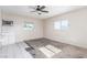 Spacious living room with a ceiling fan and a window providing natural light at 1108 Princess Katy Ave, Las Vegas, NV 89119