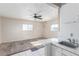 Bright living room with ample natural light, and a ceiling fan above at 1108 Princess Katy Ave, Las Vegas, NV 89119