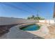 Backyard view of an in-ground pool, surrounded by a concrete deck, and a privacy wall at 1108 Princess Katy Ave, Las Vegas, NV 89119