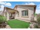 This backyard features a cozy covered patio and easy-to-maintain artificial turf, perfect for outdoor relaxation at 11139 Zarod Rd, Las Vegas, NV 89135