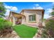 Beautiful backyard featuring a well-manicured lawn, covered patio, and lush landscaping at 11139 Zarod Rd, Las Vegas, NV 89135