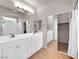 Bathroom featuring double sinks, mirrored closet, and generous cabinet space at 11139 Zarod Rd, Las Vegas, NV 89135