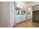 Bathroom featuring double sinks, mirrored closet, and generous cabinet space at 11139 Zarod Rd, Las Vegas, NV 89135