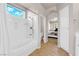 Bright bathroom with a separate soaking tub and shower combo adjacent to the bedroom at 11139 Zarod Rd, Las Vegas, NV 89135