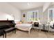 Comfortable bedroom with large window, work space, carpet, and mirrored closet doors at 11139 Zarod Rd, Las Vegas, NV 89135