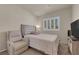 Serene bedroom featuring a cozy bed, window with shutters, and a comfortable chair at 11139 Zarod Rd, Las Vegas, NV 89135