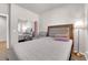 Well-lit bedroom featuring neutral decor, carpet, comfortable chair, and mirrored closet doors at 11139 Zarod Rd, Las Vegas, NV 89135