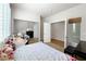 Comfortable bedroom with large window, work space, carpet, and mirrored closet doors at 11139 Zarod Rd, Las Vegas, NV 89135