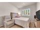 Comfortable bedroom featuring neutral decor, carpet, comfortable chair, and large window at 11139 Zarod Rd, Las Vegas, NV 89135