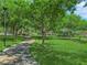 Take a leisurely walk along the shaded path in this tranquil community park with mature trees and lush grass at 11139 Zarod Rd, Las Vegas, NV 89135