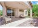 Inviting covered patio with stylish furniture, green lawn, and serene outdoor living space at 11139 Zarod Rd, Las Vegas, NV 89135